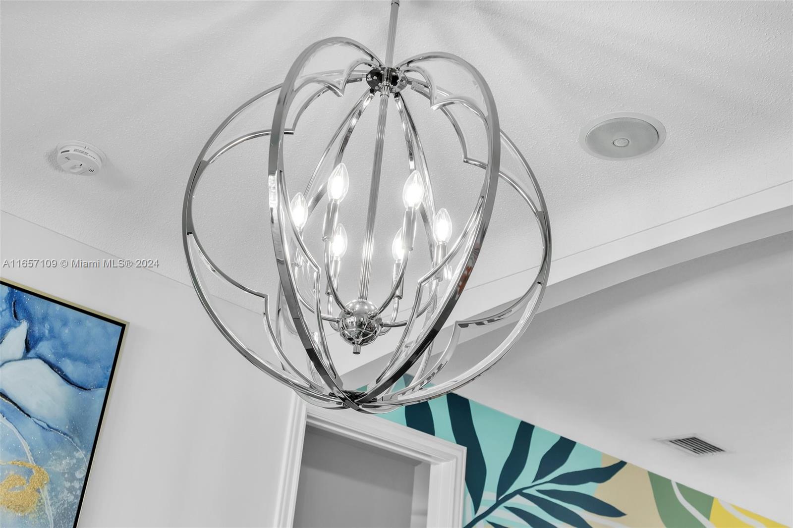 Elegant metallic heart-shaped chandelier lighting fixture in contemporary living space.